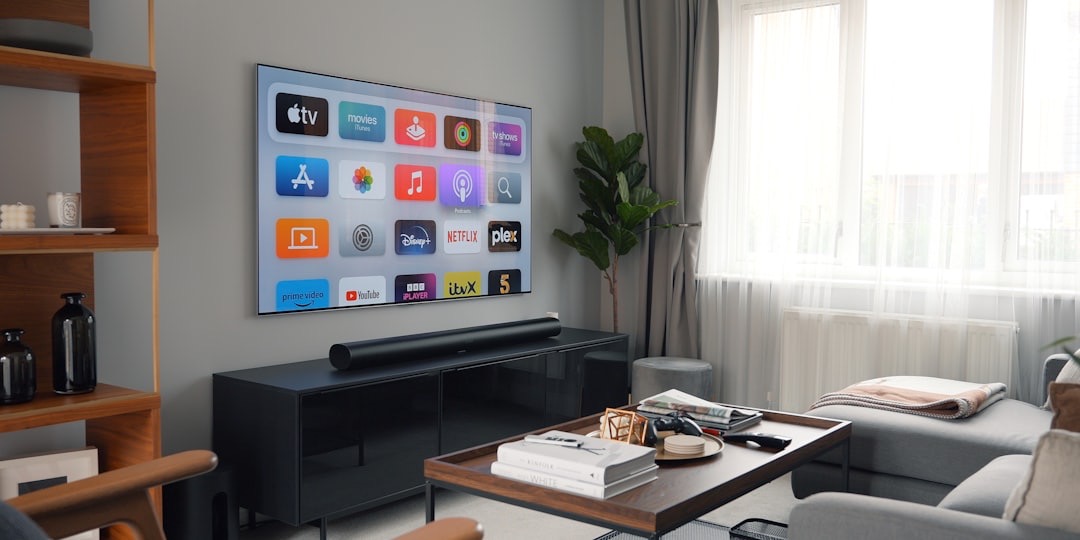A living room with furniture, a TV screen and a soundbar below it on a TV cabinet